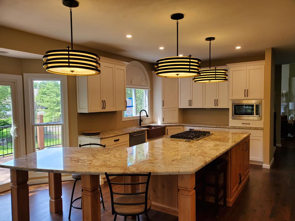 an image of a modular kitchen with lights and chairs