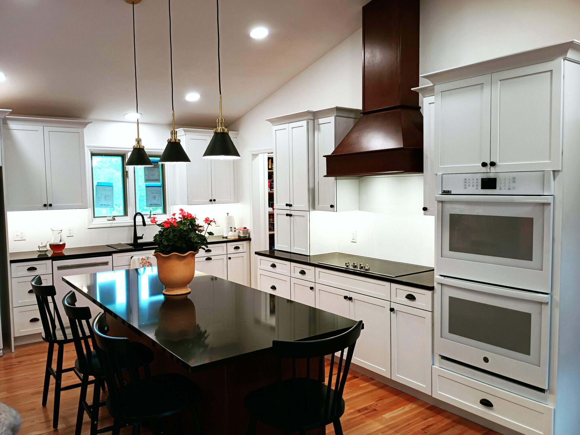 an image of a modular kitchen with lights and chairs