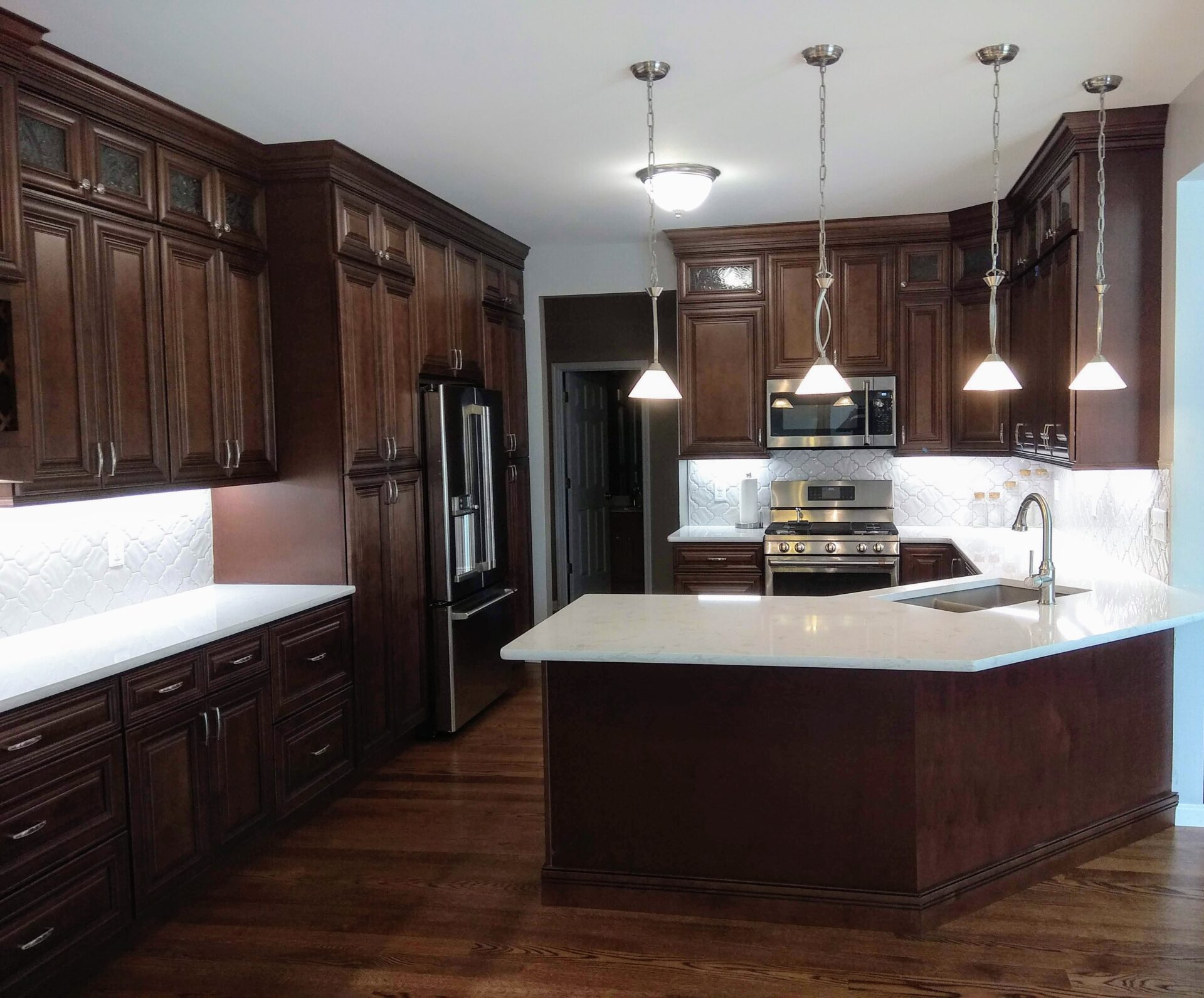 an image of a modular kitchen with lights and chairs